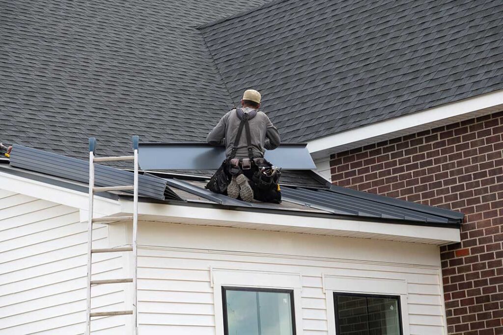 A close-up view of an asphalt shingle roof valley with visible signs of wear and missing shingles.